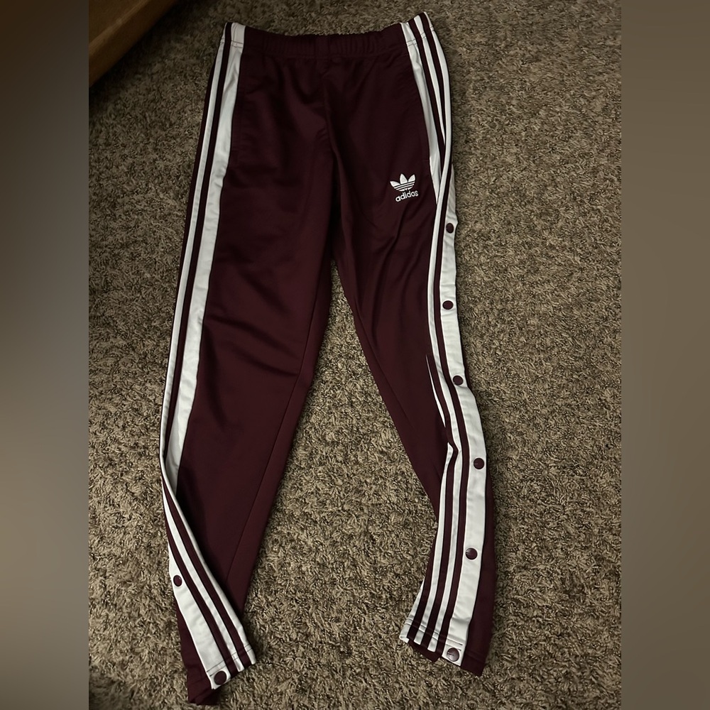 Burgundy Adidas track pants with snaps